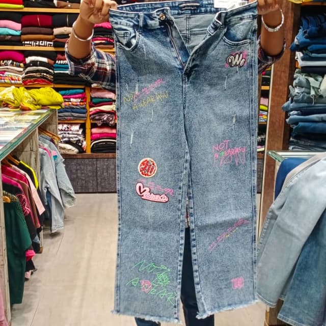 Light blue wash denim with multi-color graffiti and patches Jeans