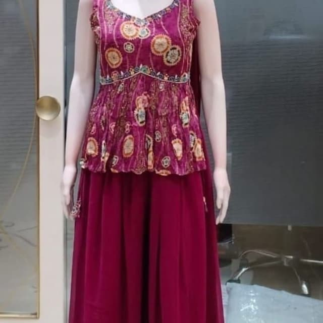 Deep magenta with multi-colored floral and geometric prints in yellow, beige, and black Peplum top with a skirt