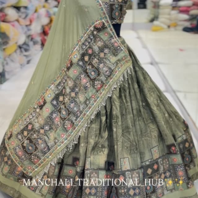 Olive green with multi-colored geometric prints and accents in beige, brown, red, and blue. Lehenga Choli
