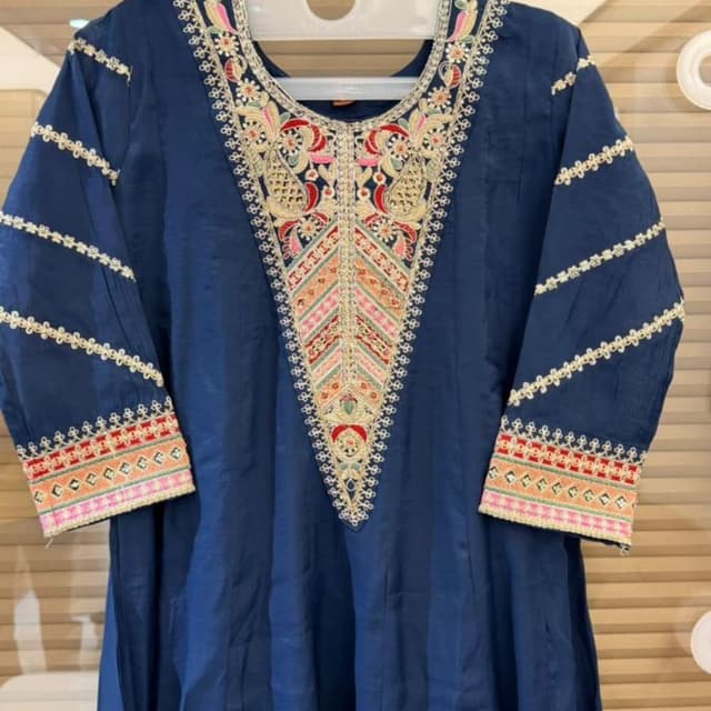 Deep blue base with multi-colored embroidery including red, yellow, green, and gold Kurti