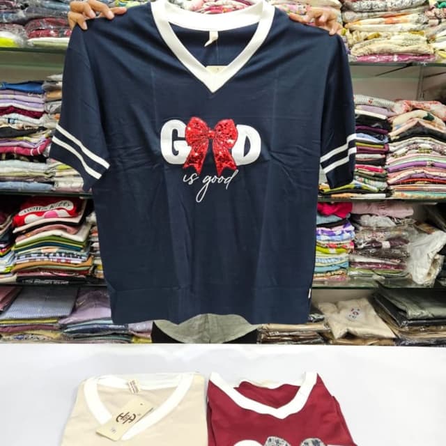 Navy blue with white trim, red bow, white text T-shirt