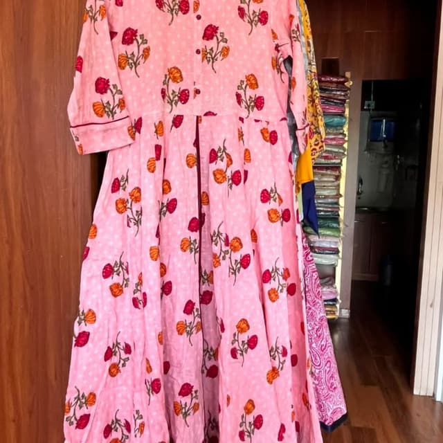 Pink with floral print in red and orange, dotted with white Kurti
