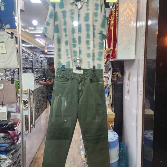 Teal and off-white/cream tie-dye pattern on shirt, olive green pants Short-sleeved shirt and jeans set