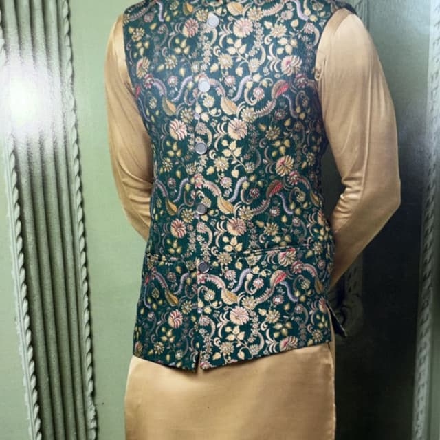 Dark Green with floral patterns in gold, pink, and cream, paired with a golden silk kurta and trousers Nehru jacket (Modi jacket) worn over a kurta-pyjama set