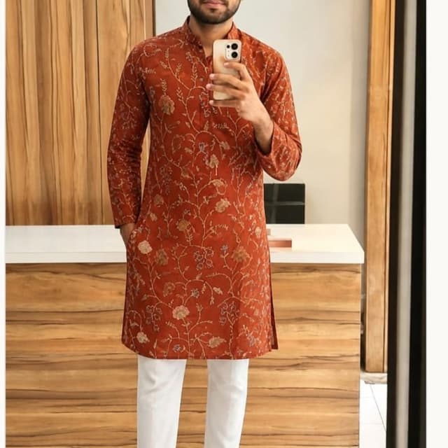 Rust orange base with subtle muted floral tones in beige and olive Kurta