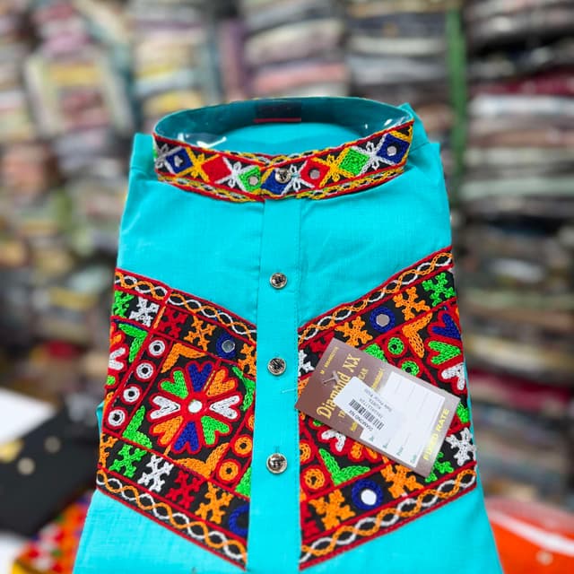 Bright turquoise blue base with multi-colored embroidery including red, yellow, green, orange, and blue Kurta