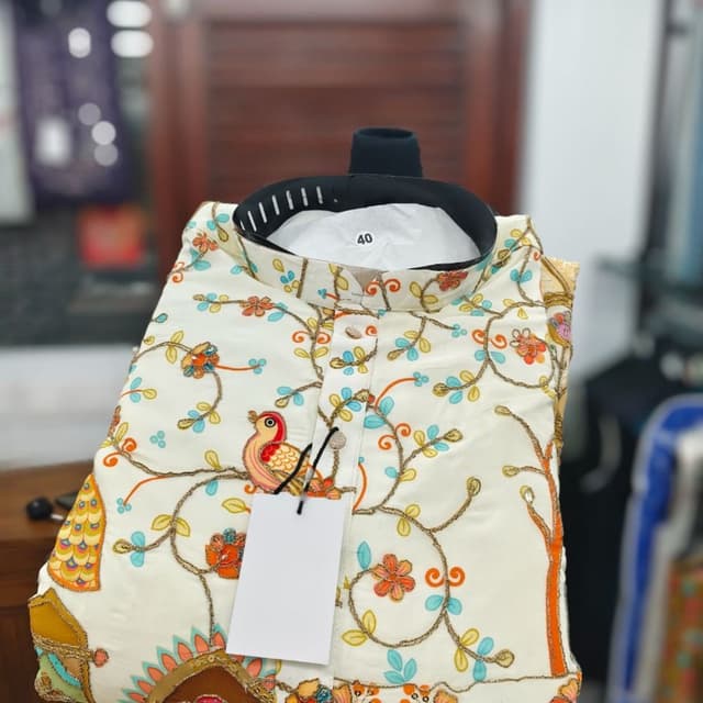 Off-white base with multicolor floral and bird embroidery in shades of orange, light blue, and green Kurta