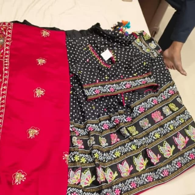 Black base with pink, lime green, yellow, and white accents Lehenga Choli