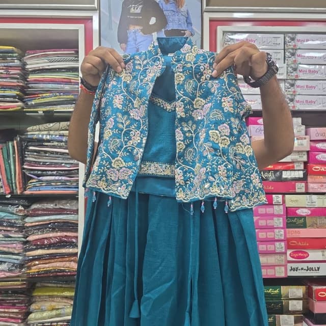 Teal blue base with multicolored floral embroidery in pink, yellow, and white Lehenga Choli with Jacket