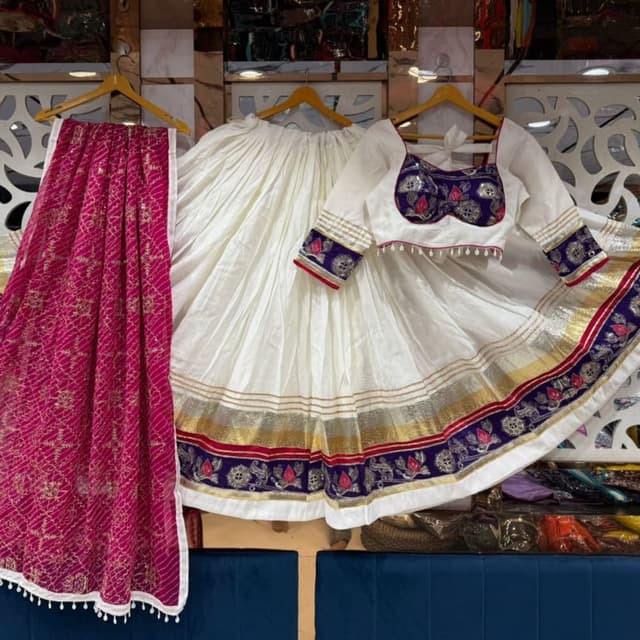 Off-white base, deep purple, magenta, gold, and silver Lehenga Choli
