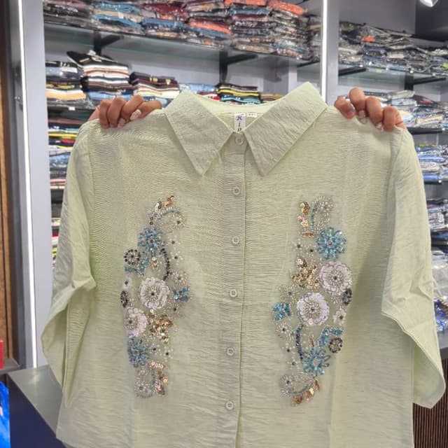 Light sage green with blue, white, and gold accents Shirt