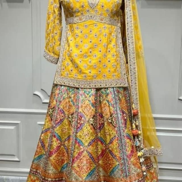 Bright yellow, orange, multi-colored geometric accents, and purple hem details Lehenga Choli