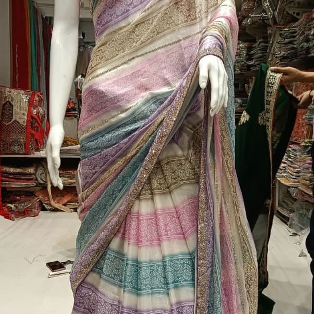 Multi-colored pastel stripes including lavender, teal, soft pink, and white with gold accents Saree