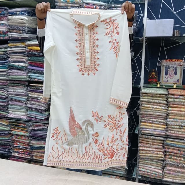 Off-white base with rust, gold, and green embroidery accents Kurta