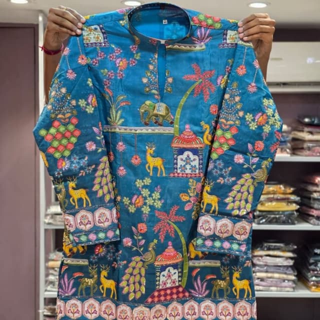 Teal blue base with multi-colored embroidery including pink, green, yellow, and orange Kurta