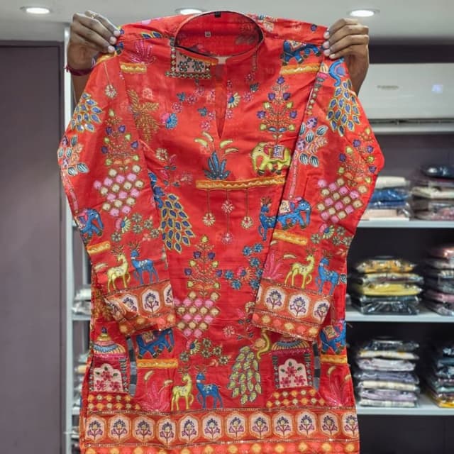 Red base with multicolored prints in blue, yellow, pink, green, and orange Kurti