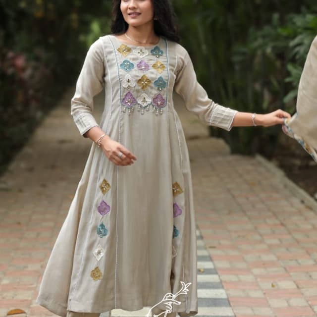 Beige base with multicolored floral-shaped patches in mustard, purple, white, and teal Kurta set