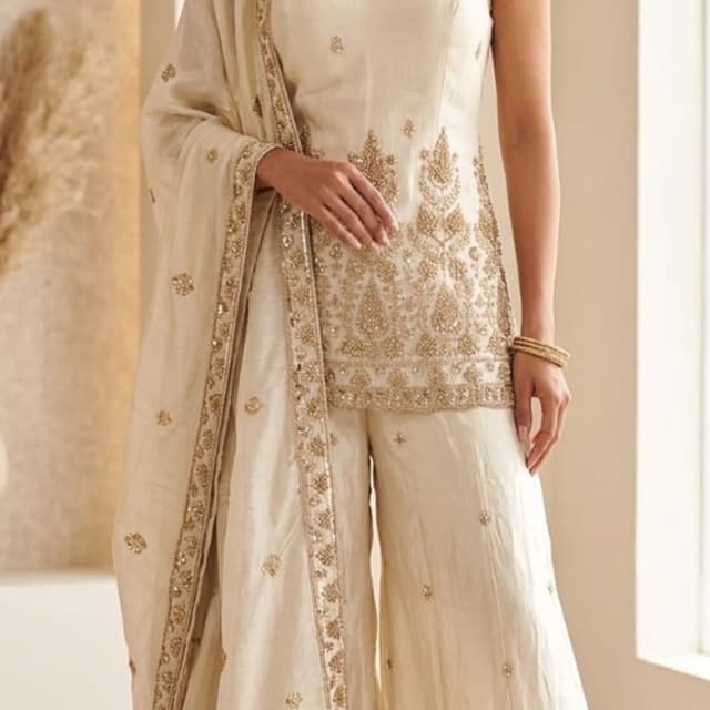 Off-white or cream base with metallic gold embroidery Sharara Set