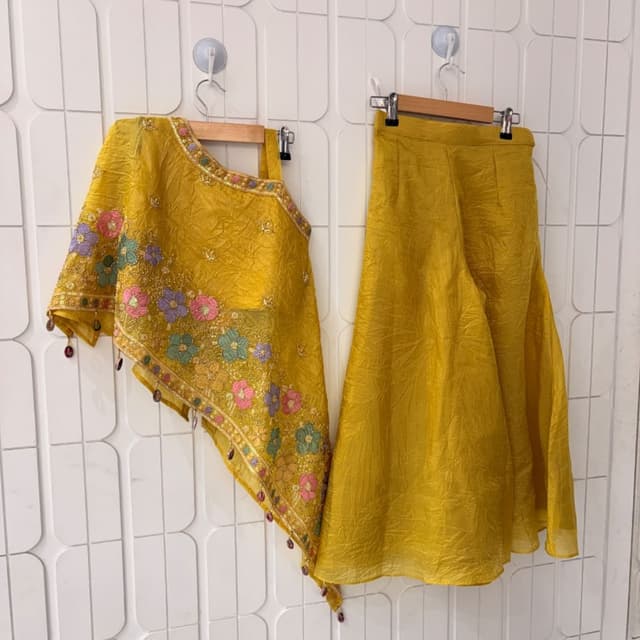 Mustard Yellow base with multi-colored floral accents in pink, light green, and lavender Lehenga Choli set