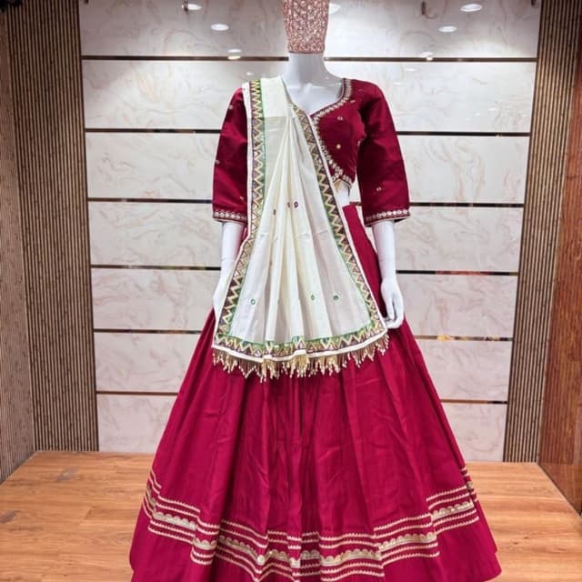 Deep maroon or wine red with off-white and hints of green and gold Lehenga Choli