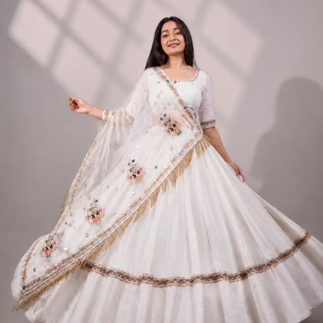 White base with multicolored floral accents and gold detailing Lehenga Choli