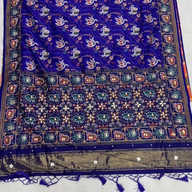 Deep Royal Blue base with accents of red, green, white, and metallic gold Saree