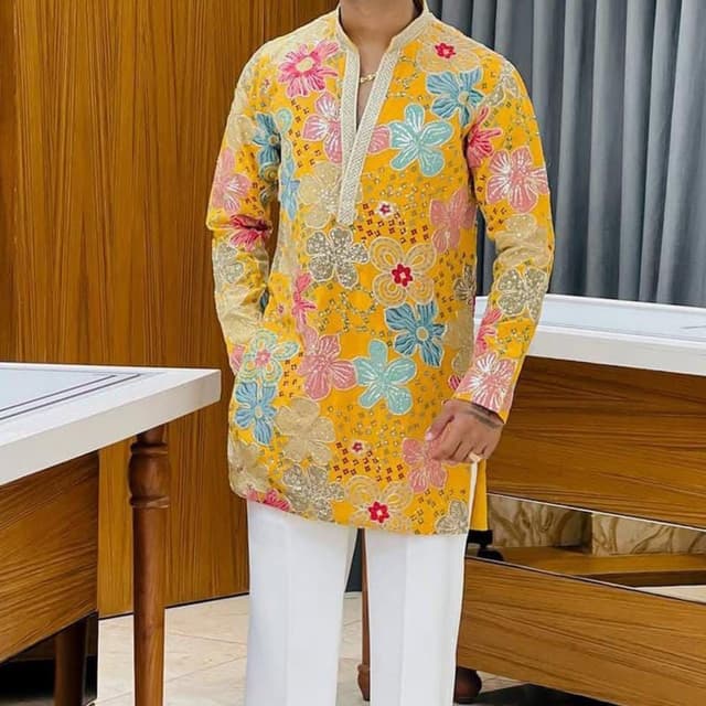 Vibrant yellow base with multi-colored floral embroidery in shades of pink, turquoise, and metallic gold Kurta