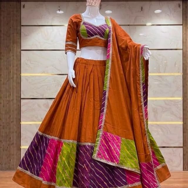 Burnt orange base with fuchsia pink, lime green, and royal purple accents Lehenga Choli