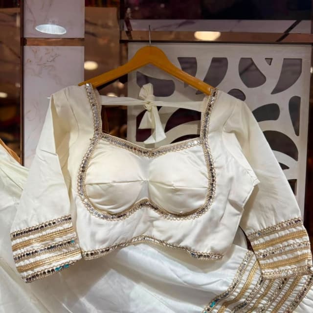 Off-white base with gold and multi-colored accents Blouse