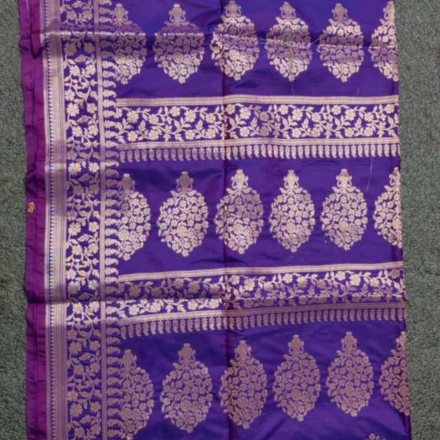 Deep purple base with gold metallic zari accents Saree