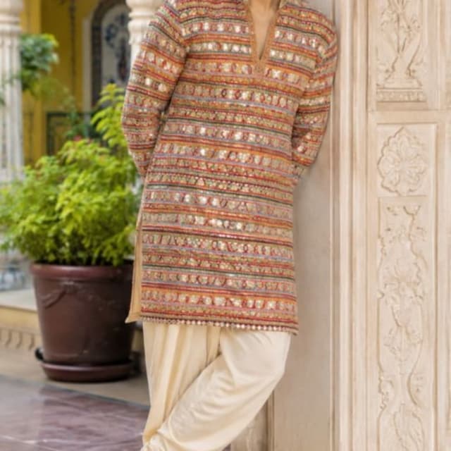 Multi-colored striped patterned kurta with cream-colored solid trousers Kurta with Dhoti-style pants