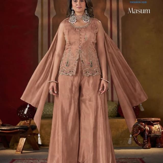 Dusty peach or light copper brown Peplum top with cape-style sleeves and wide-leg trousers