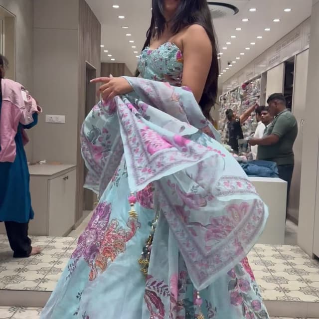 Light blue base with shades of pink, purple, and hints of orange floral motifs Lehenga Choli