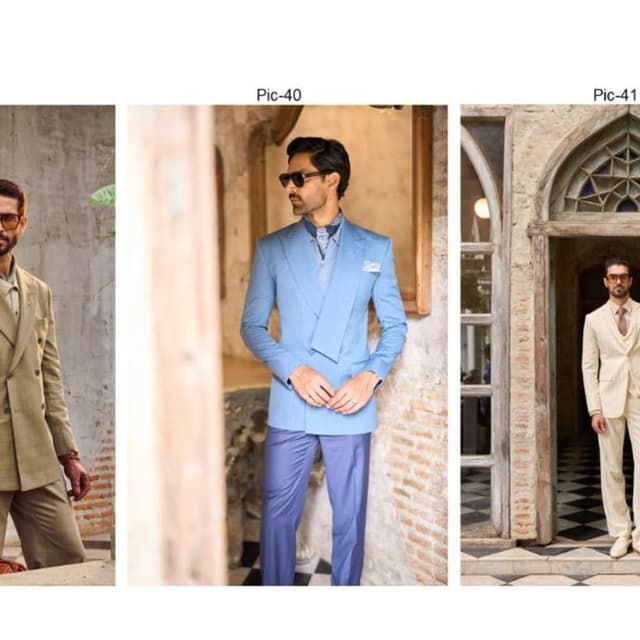 Light blue blazer, darker blue trousers, patterned blue neck accessory Suit