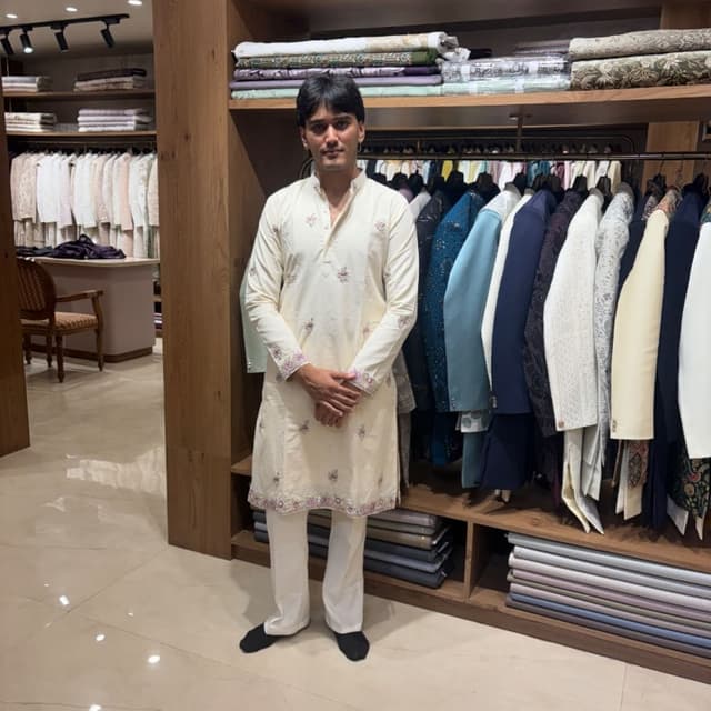 Off-white or cream base with pastel pink and green floral embroidery Kurta Pyjama set