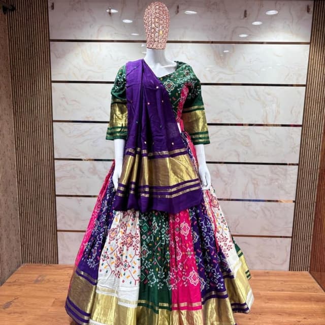 Multi-colored including deep purple, emerald green, vibrant pink, and white with metallic gold accents Lehenga Choli