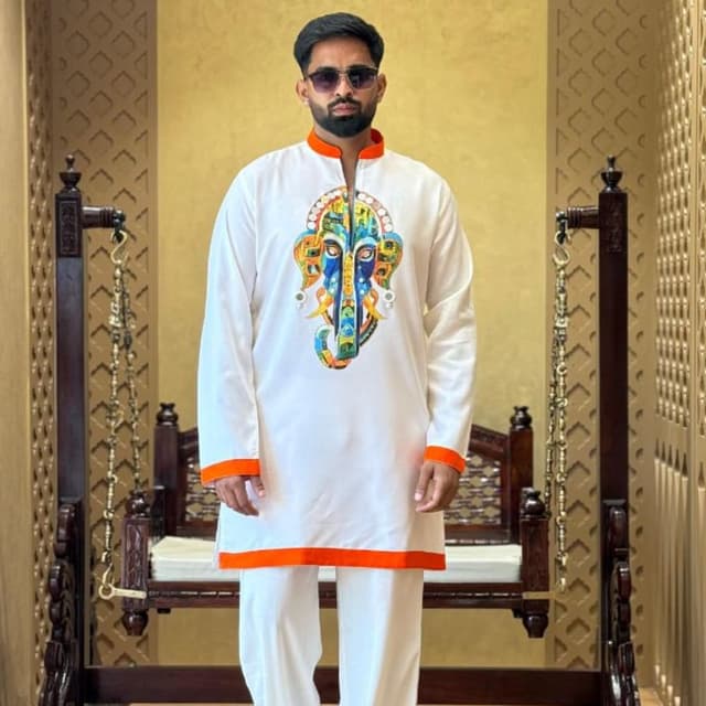White base with orange accents and a multi-colored graphic print Kurta Pyjama set