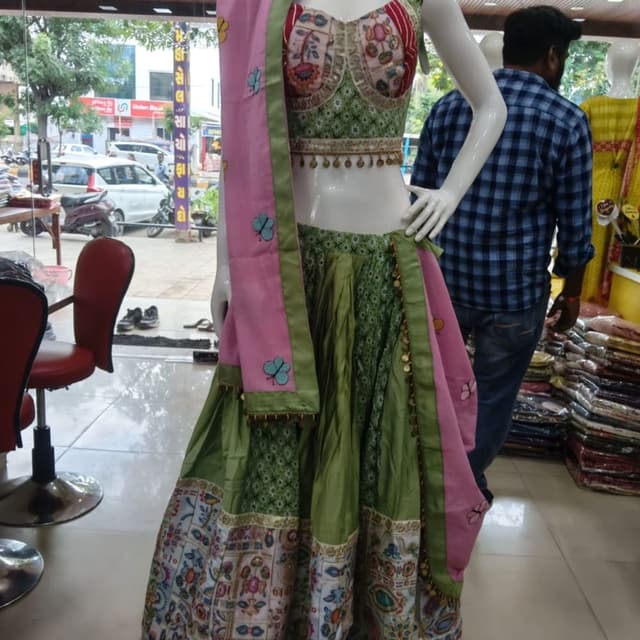 Olive green, pastel pink, white, multi-colored accents Lehenga Choli