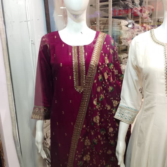 Deep maroon or wine with gold and green accents Salwar Kameez