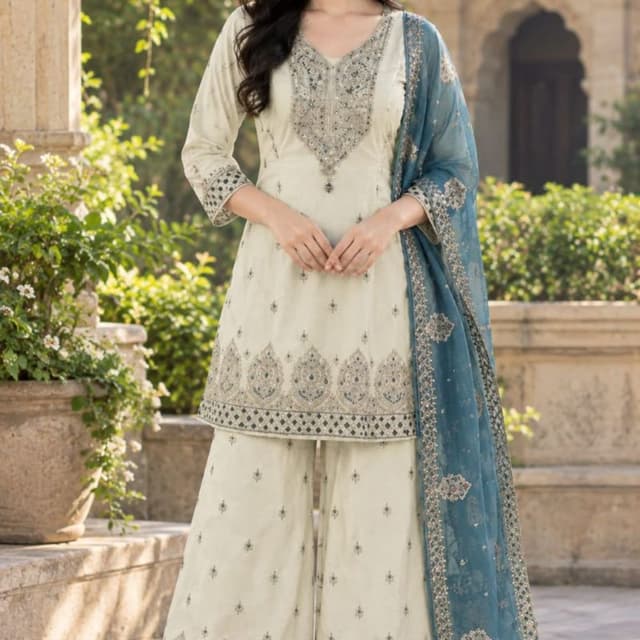 Off-white or cream base with teal, gold, and dusty blue embroidery Sharara Set