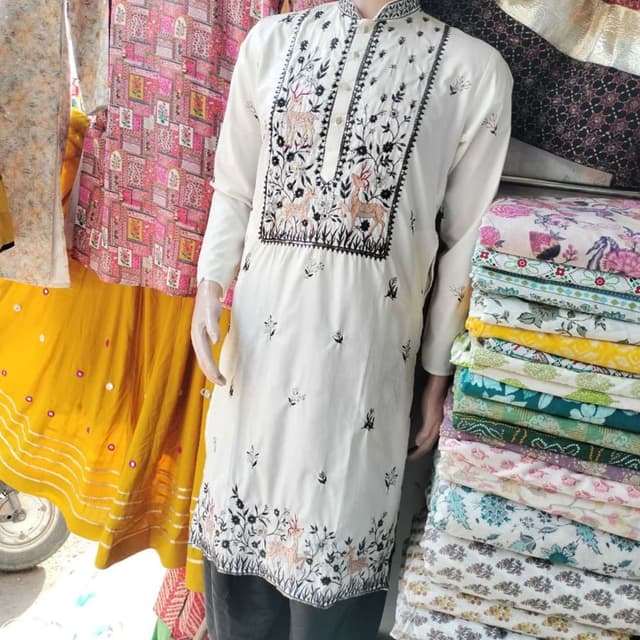 Off-white base with black embroidery and subtle brown/tan accents on the animal motifs Kurta