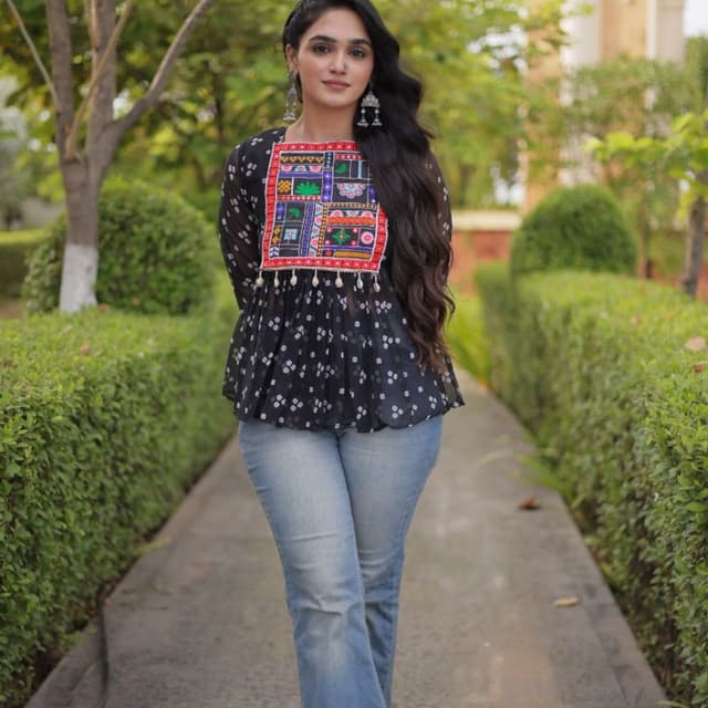 Black base with multi-color embroidery including red, green, blue, yellow, and white Peplum Top