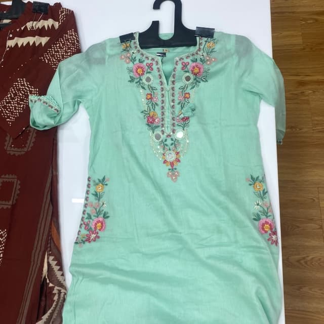Mint green base with multi-colored floral embroidery (pink, yellow, cream, and green) Kurti