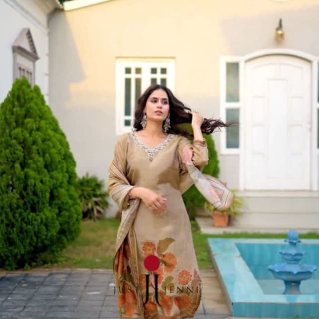 Taupe or warm beige base with vibrant orange and green floral accents Salwar Suit Set