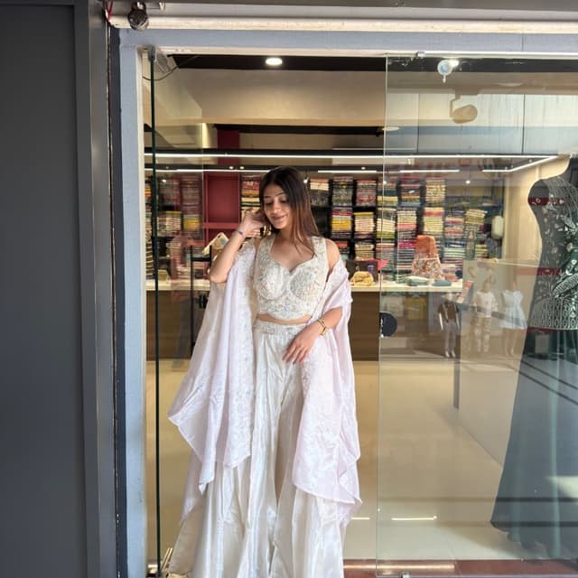 Off-white, cream, and soft pastel undertones Lehenga Choli with Cape
