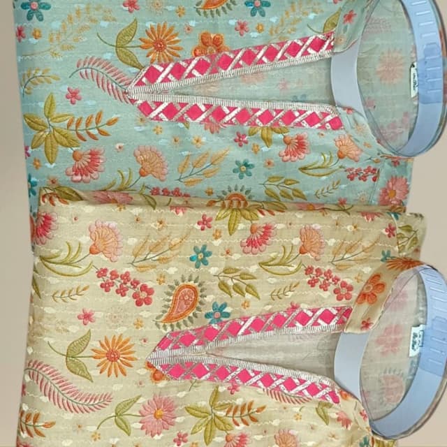 Pastel mint green and beige base with multicolored floral embroidery in pink, orange, yellow, and blue Kurta