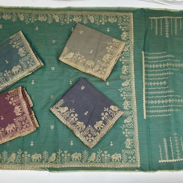 Teal green base with slate grey, muted brown, and metallic gold embroidery Saree