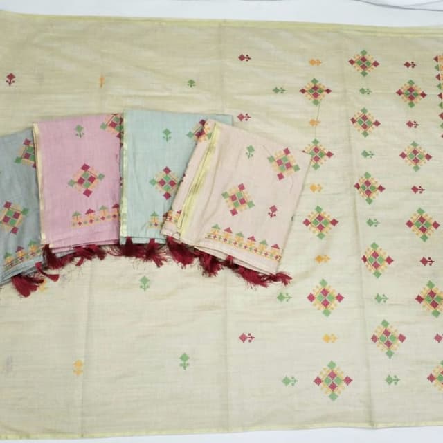 Pastel shades like cream, dusty pink, mint green, and beige, accented with vibrant red, green, and yellow embroidery Saree