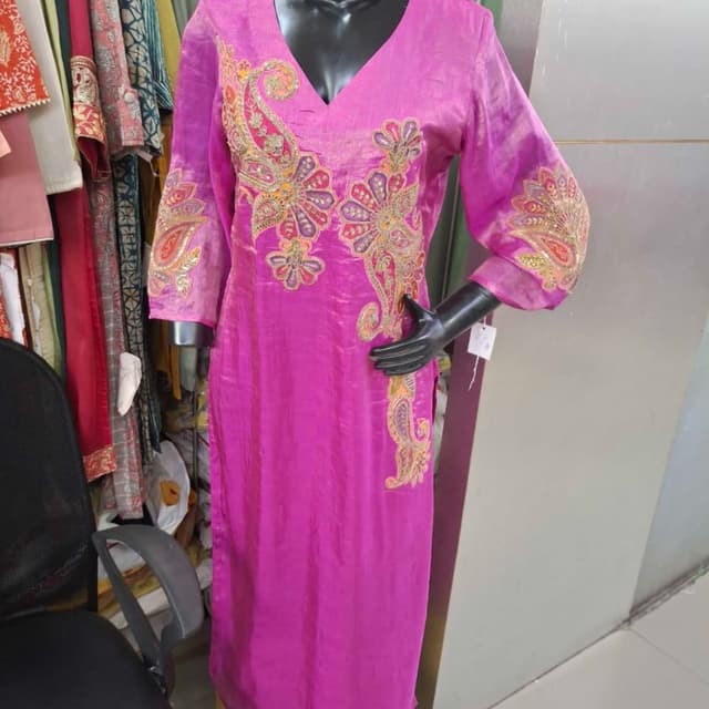 Vibrant magenta pink base with multicolor embroidery including orange, purple, gold, and green Kurti