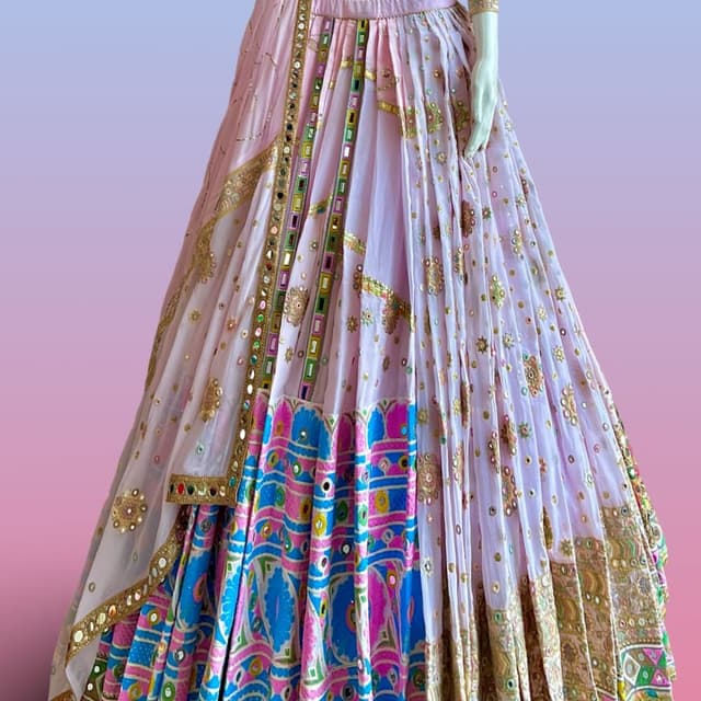 Light pink base with vibrant multi-colored accents including bright blue, hot pink, yellow, and green Lehenga Choli